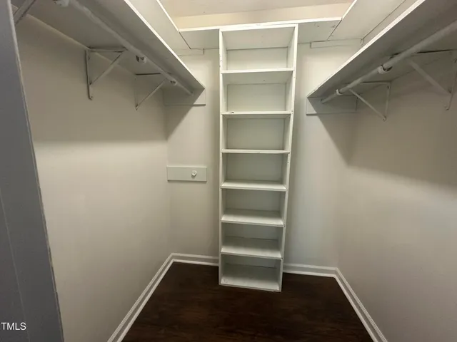 a view of walk in closet with empty racks