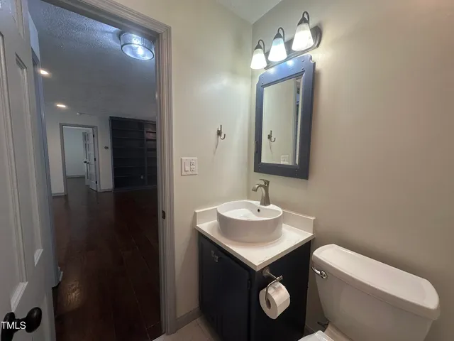 a bathroom with a toilet sink and mirror