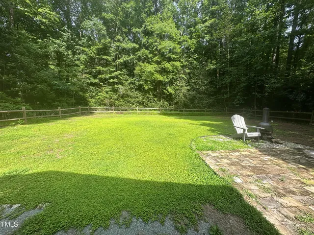 a swimming pool with trees in the background