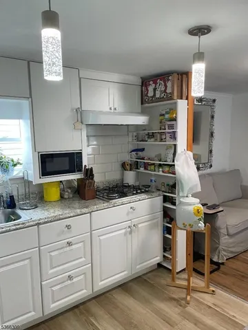 a kitchen with stainless steel appliances granite countertop a stove and a sink