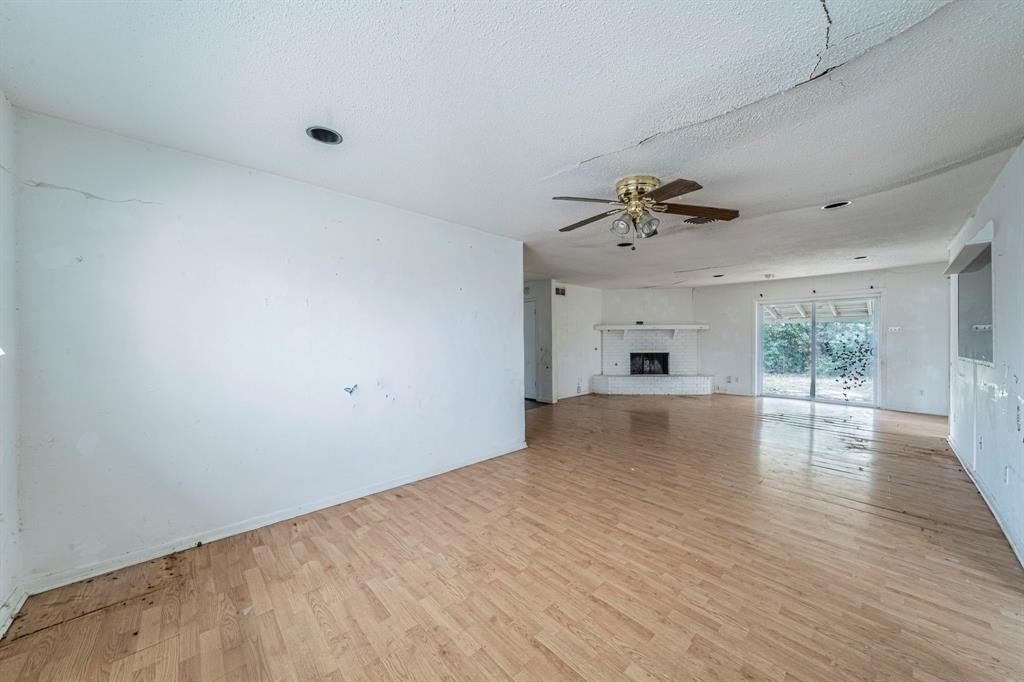 3816 Springbranch Drive Benbrook, TX 76116 - Photo 8 of 27 wooden floor in an empty room with a window