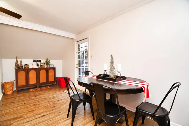 a view of a dining room with furniture and wooden floor