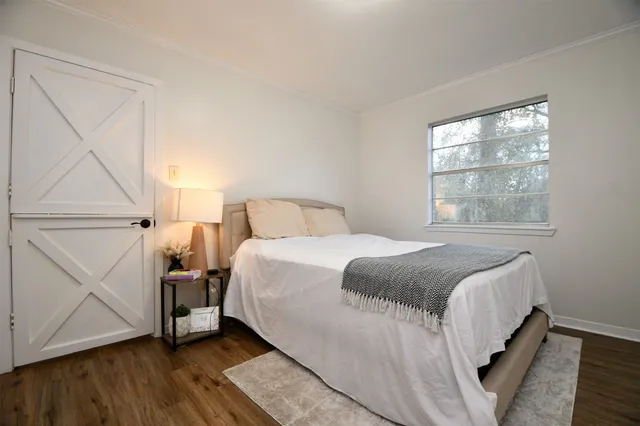 a bedroom with a bed and window