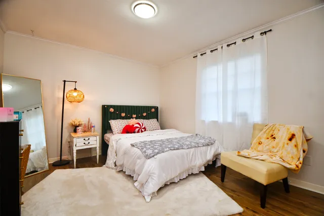 a bedroom with a bed and a couch