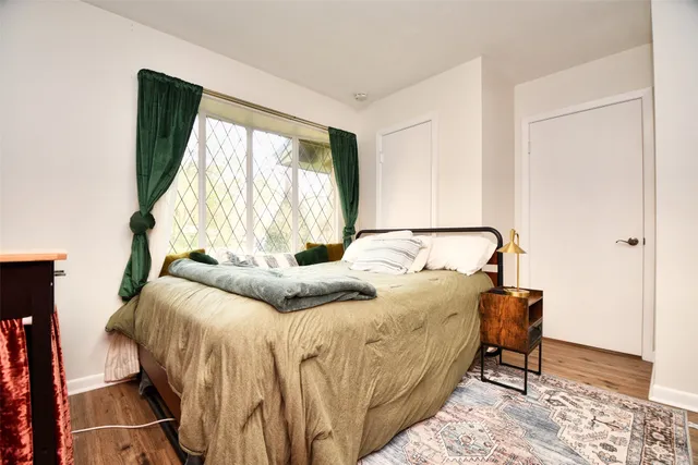 a bedroom with a bed and a window