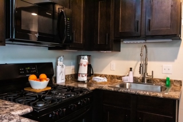 8 Holly Tree Court Monteagle, TN 37356 - Photo 7 of 14 a kitchen with stainless steel appliances wooden cabinets and a stove top oven