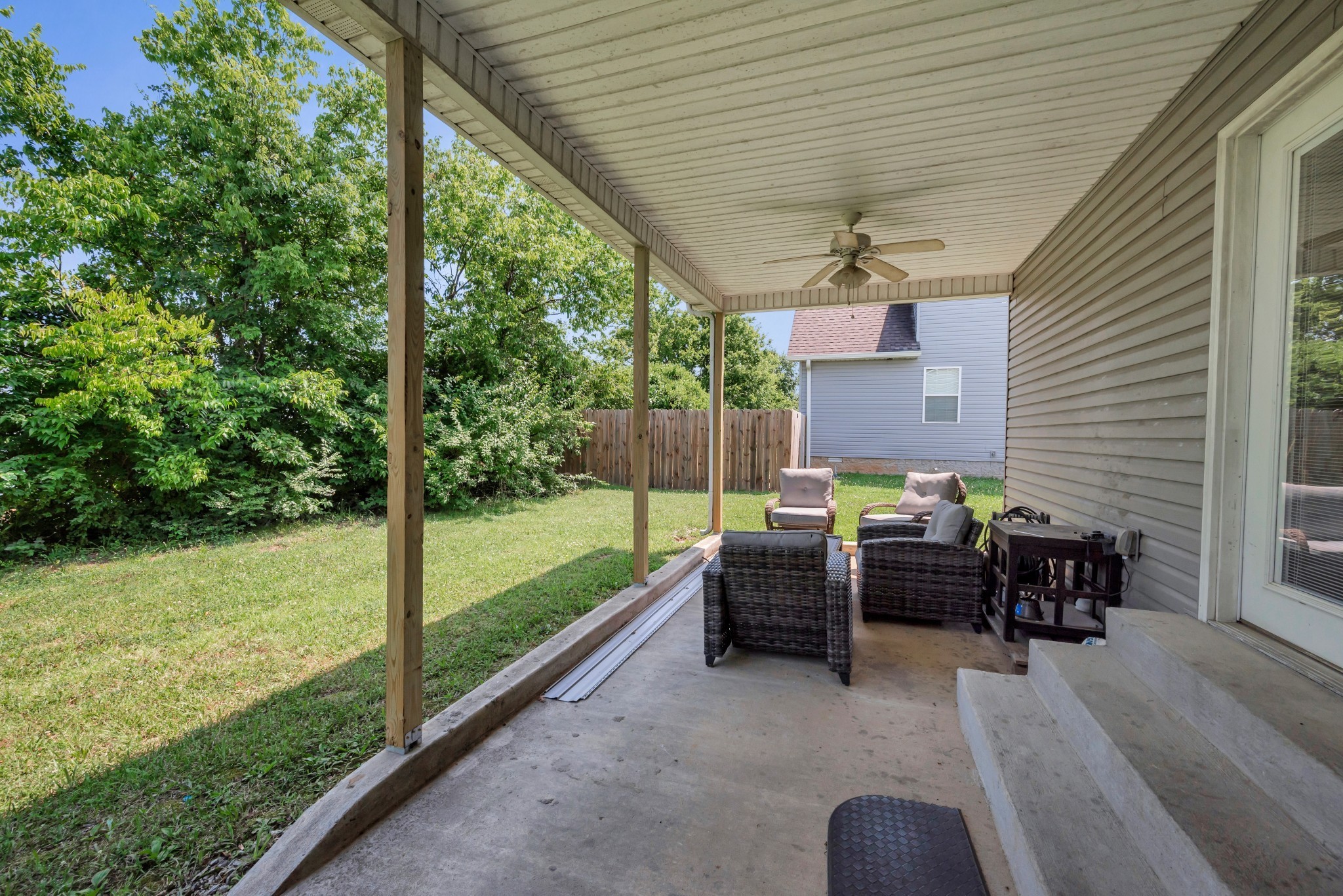 756 Maylene Drive Madison, TN 37115 - Photo 19 of 25 a view of a patio with table and chairs potted plants with wooden floor and fence