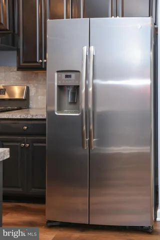 a kitchen with a refrigerator and a sink