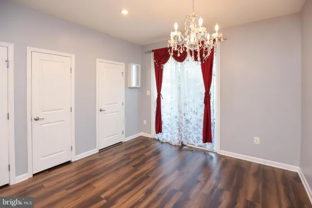 a view of a livingroom with wooden floor and chandelier