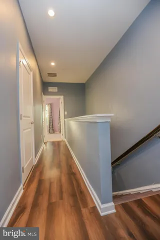 a view of hallway with wooden floor
