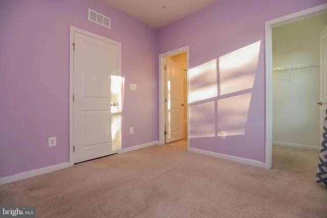 an empty room with mirror on the wall