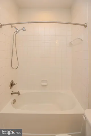 a bathroom with a shower and a bath tub