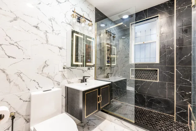 a bathroom with a sink toilet and shower