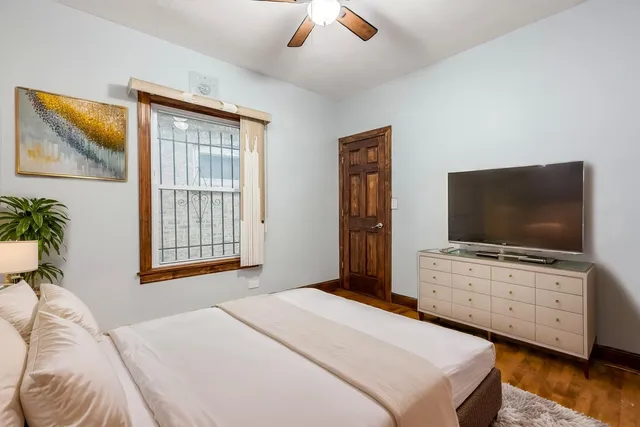 a bedroom with a bed and a flat screen tv