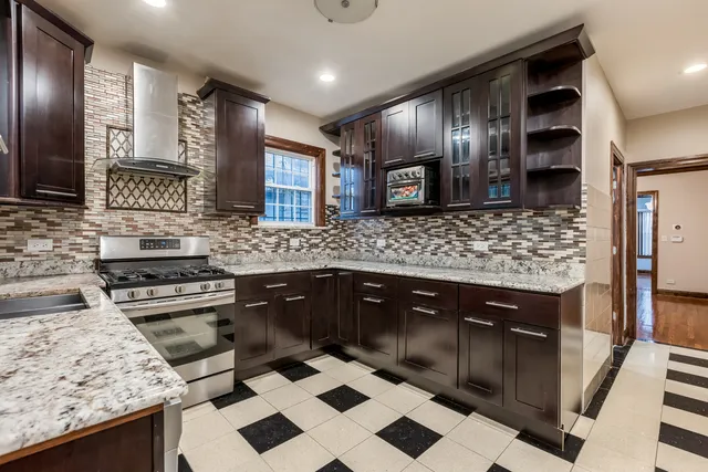 a kitchen with a stove sink and cabinets