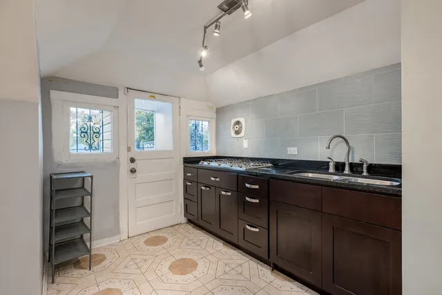 a kitchen with a sink and cabinets