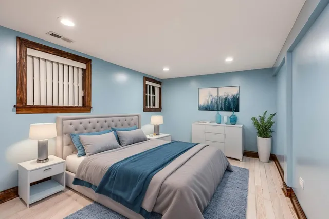 a bedroom with a large bed and a wooden floor