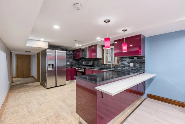 a kitchen with stainless steel appliances granite countertop a stove a refrigerator and a oven