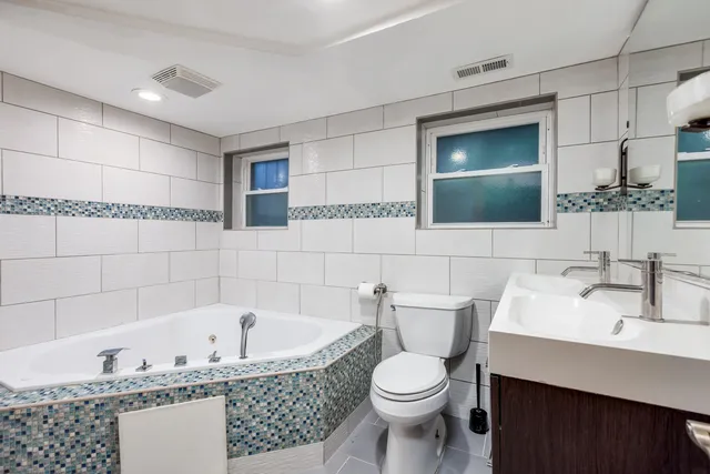 a bathroom with a bathtub a sink and a toilet