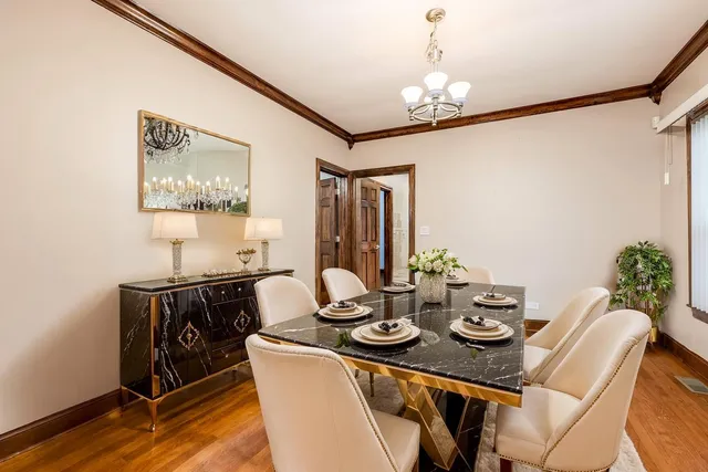 a view of a dining room with furniture and chandelier