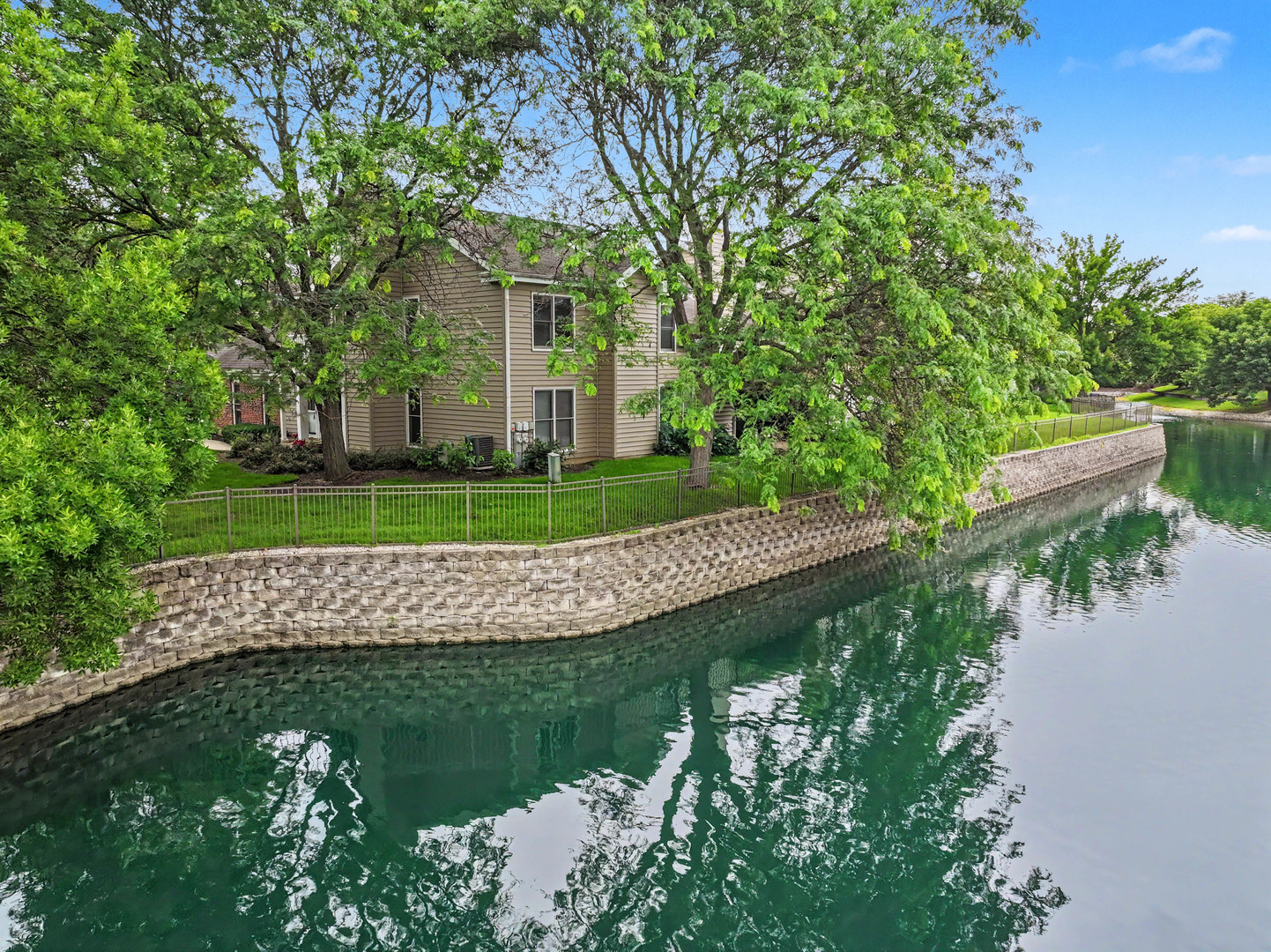 1953 North Coldspring Road Arlington Heights, IL 60004 - Photo 4 of 27 a view of a white house with a yard and a large tree