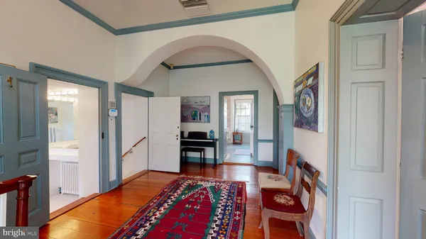 a bedroom with furniture and a wooden floor