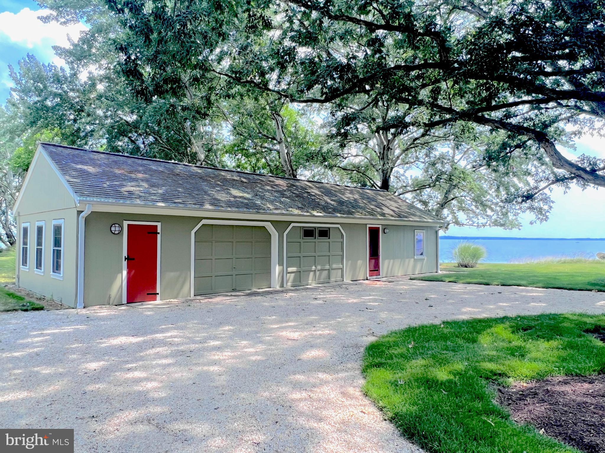 27295 Southside Island Creek Road Trappe, MD 21673 - Photo 42 of 91 a front view of a house with a yard and garage