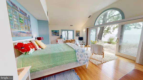a view of hall way with furniture and wooden floor