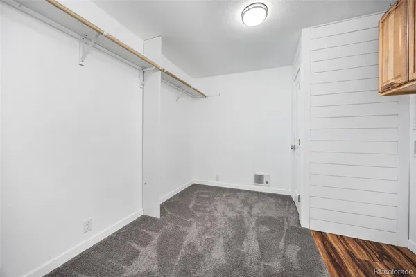 a view of a room with wooden floor