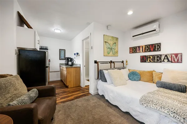 a bedroom with furniture and a flat screen tv