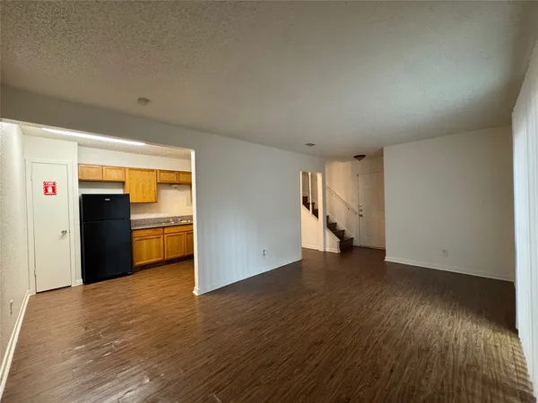 a view of an empty room with closet and a window
