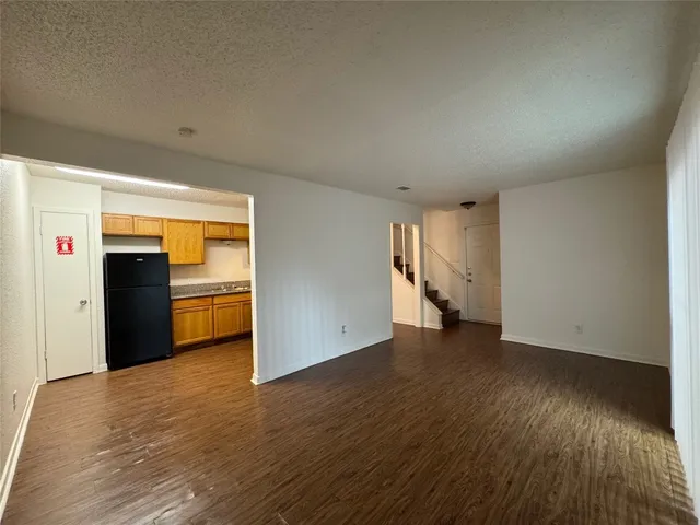 a view of empty room with wooden floor and closet