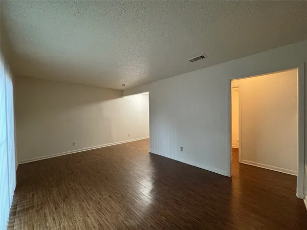 an empty room with wooden floor