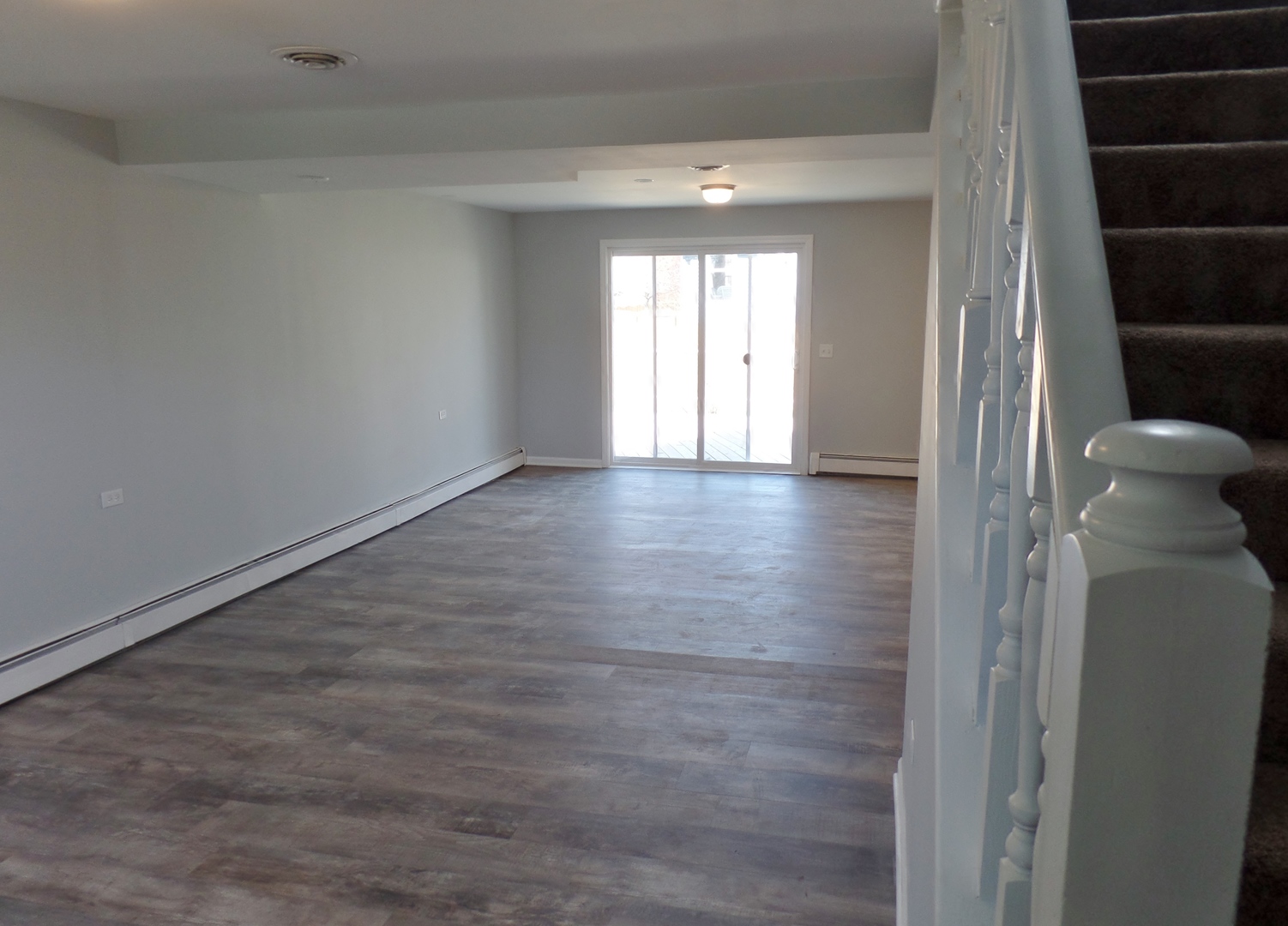 1504 Comanche Drive Bolingbrook, IL 60490 - Photo 21 of 34 a view of an empty room with a window and wooden floor