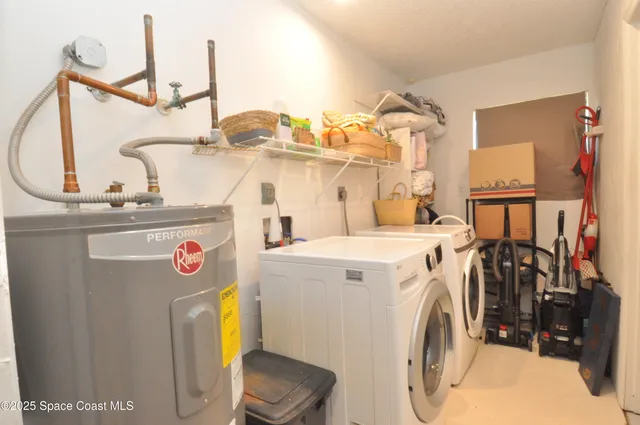 a view of storage and utility room with a washer and dryer