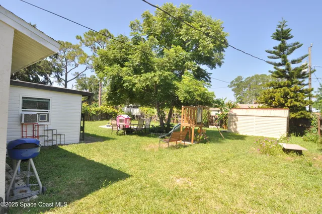 a view of a house with backyard sitting area and garden