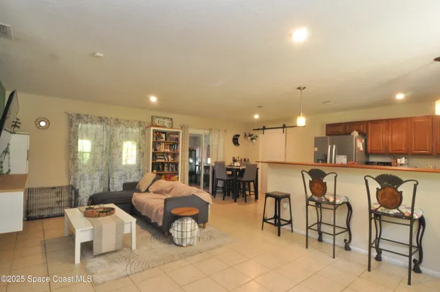 a living room with lots of furniture and white appliances