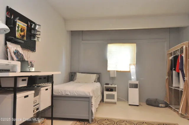 a bed room with a bed and a television