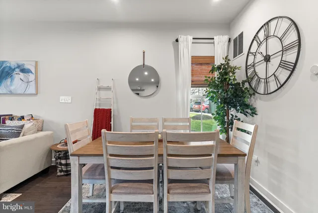 a view of a dining room with furniture and a large window