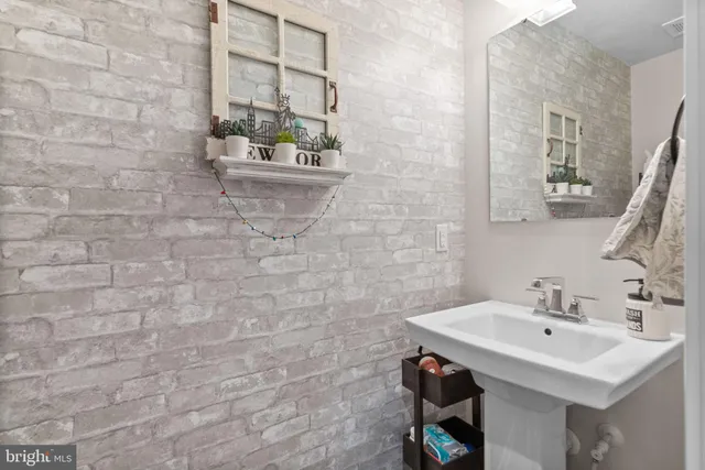 a bathroom with a sink a mirror and a toilet