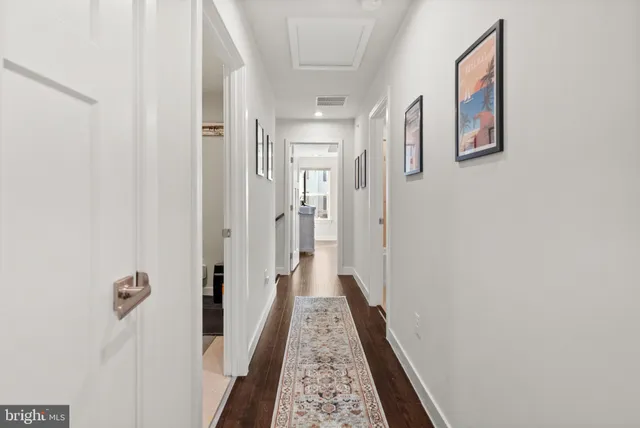 a view of hallway with wooden floor