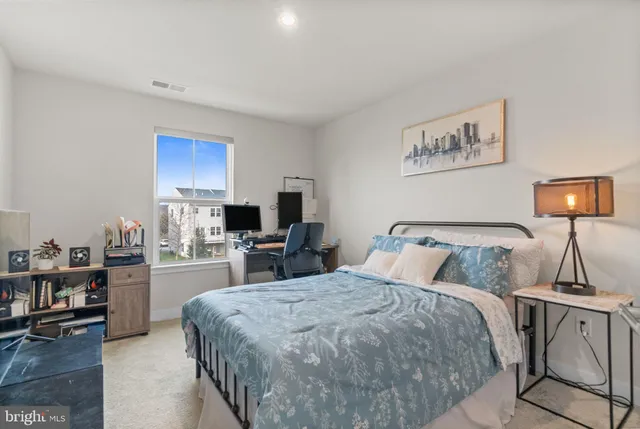 a bedroom with a bed a table and chair