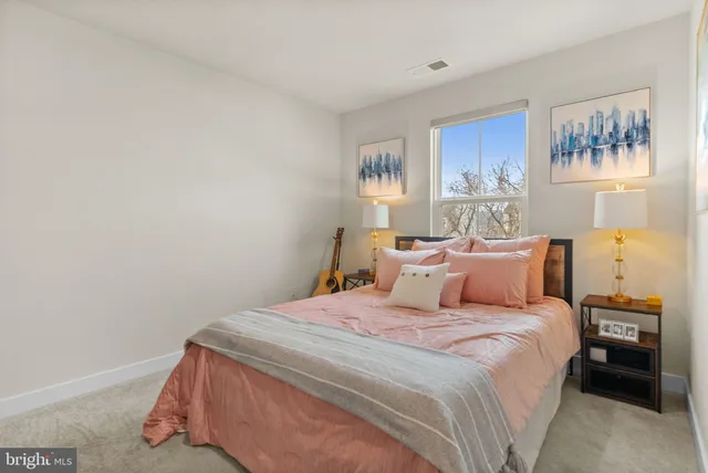 a bedroom with a bed and a night stand