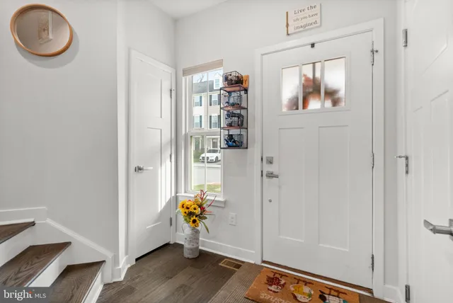a view of an entryway with wooden floor