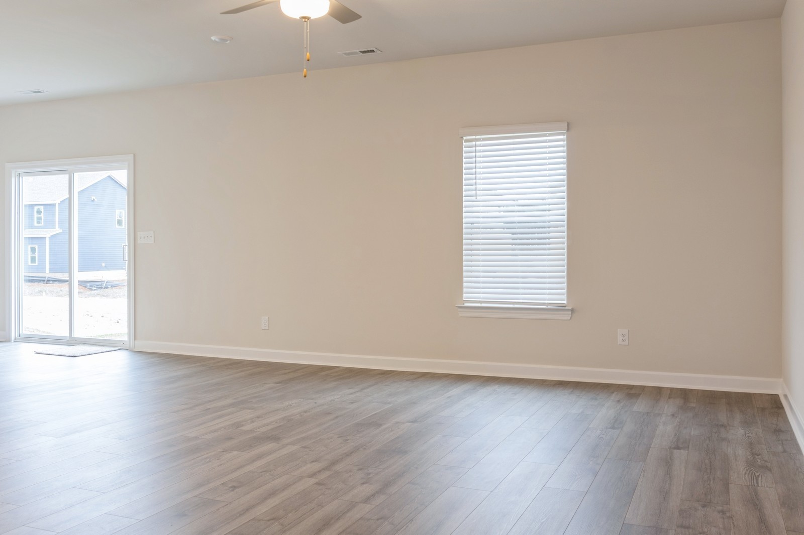 2341 Nabali Way Murfreesboro, TN 37127 - Photo 20 of 23 an empty room with wooden floor exposed radiator and windows