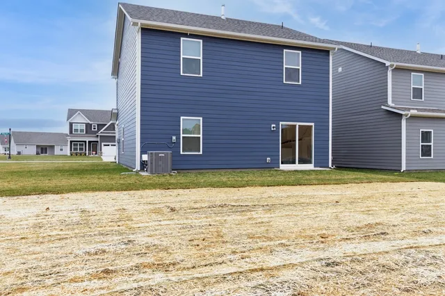 a view of a brick house with a yard