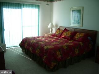 0 Edward Taylor Road, Unit 35 Ocean City, MD 21842 - Photo 4 of 10 a bed sitting in a bedroom next to a window