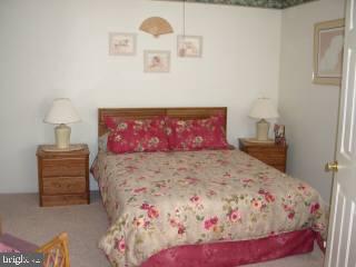0 Edward Taylor Road, Unit 35 Ocean City, MD 21842 - Photo 8 of 10 a bedroom with a bed and a couch