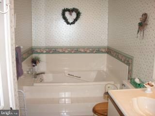 0 Edward Taylor Road, Unit 35 Ocean City, MD 21842 - Photo 9 of 10 a bathroom with a tub and a sink