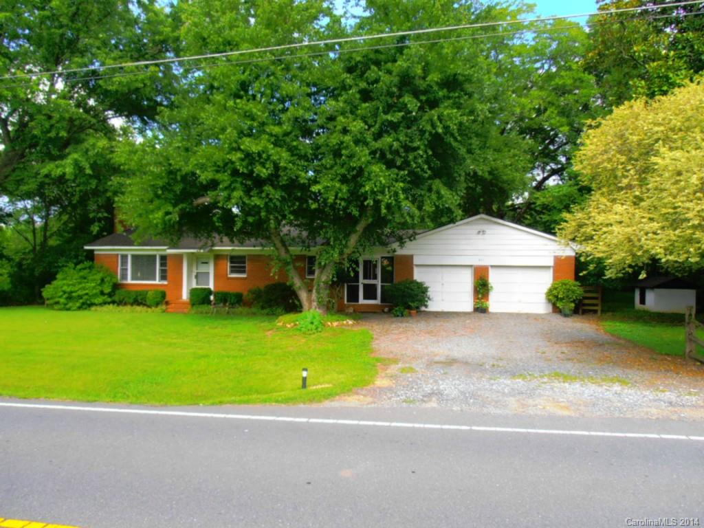 a view of a house with a backyard and a garden